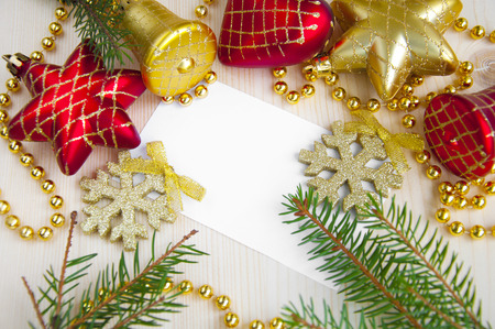Christmas card surrounded by decorations on wooden backgroundの写真素材