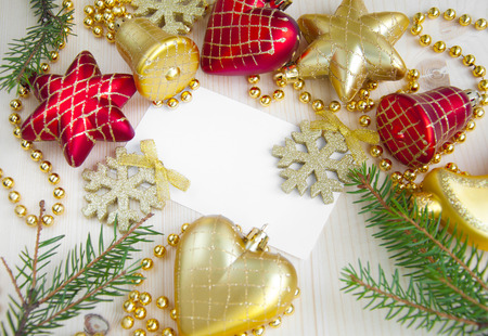 Christmas card surrounded by decorations on wooden backgroundの写真素材