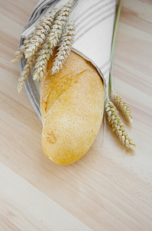 Bread and wheat on a wooden backgroundの写真素材