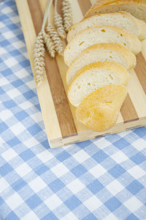 Bread and wheat on a wooden backgroundの写真素材
