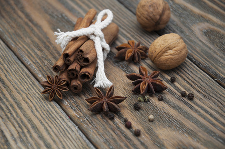 Spices set.Cinnamon stick,star anise and walnut on a wooden の写真素材