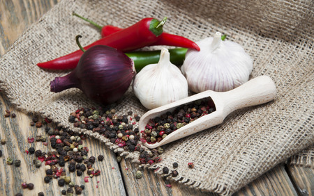 Spices set.?hili peppers, garlic, onions, peppers peas on the wooden backgroundの写真素材