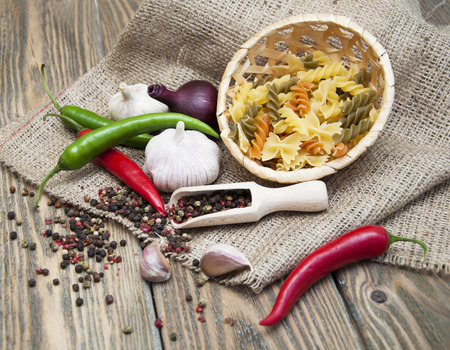 Traditional ingredients for seasoning of a good plate of pasta on a wooden backgroundの写真素材