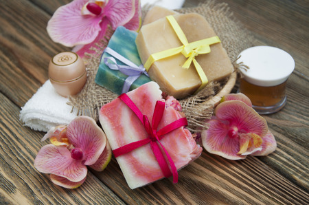 Assorted natural soaps in basket on a vintage wooden tableの写真素材