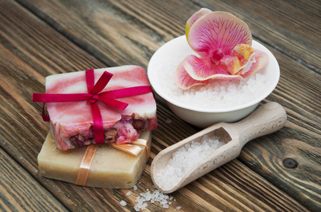 Assorted natural soaps on a vintage wooden tableの写真素材
