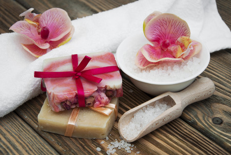 Assorted natural soaps on a vintage wooden tableの写真素材