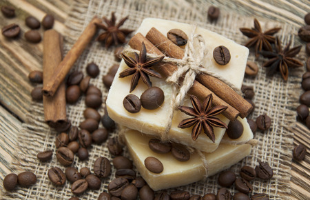 Handmade soap with coffee beans and spices on a wooden backgroundの写真素材