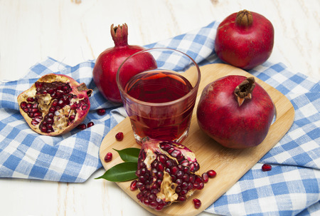 Pomegranate juice in a glass on a wooden backgroundの写真素材