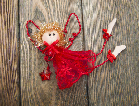 Cute Christmas angel over old wooden backgroundの写真素材