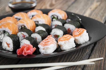 Different sushi rolls,wasabi and ginger on a plateの写真素材