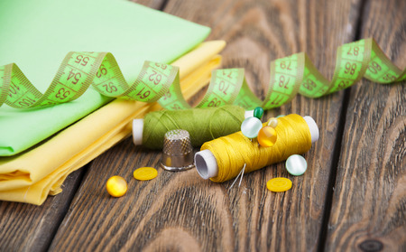 Set of different sewing accessories,fabrics and thread spools