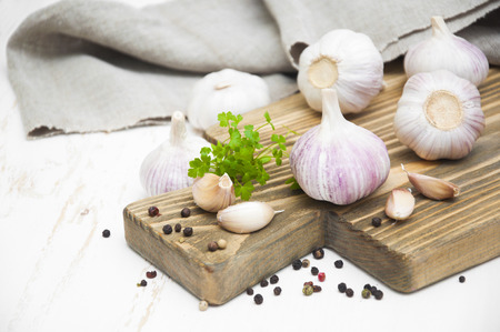 Garlic and spises on a white wooden backgroundの写真素材