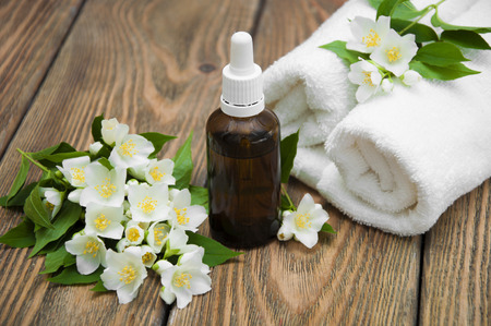The essential oil of jasmine on background - spa compositionの写真素材