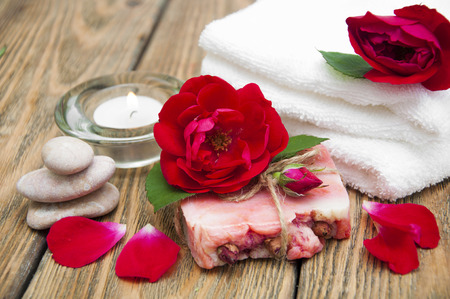 Rose handmade soap with flowers roses on a wooden backgroundの写真素材
