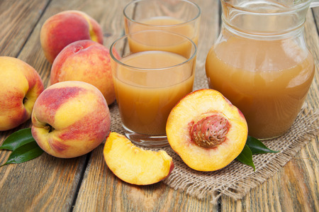 Fresh peach juice on a wooden backgroundの写真素材