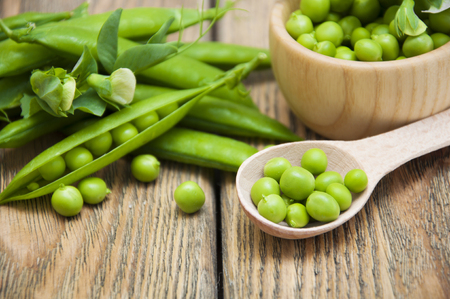 Organic green peas on a wooden backgroundの写真素材