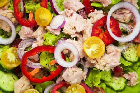 A fresh and colorful tuna salad on a wooden background - food backgroundの写真素材