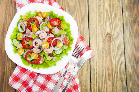 A fresh and colorful tuna salad on a wooden backgroundの写真素材