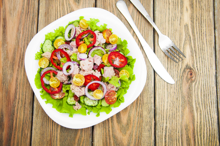 A fresh and colorful tuna salad on a wooden backgroundの写真素材