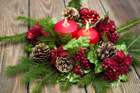 Christmas decoration with red candle on the wooden table. Christmas still life background