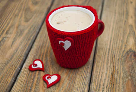 A cup of cappuccino with heart on a wooden backgroundの写真素材