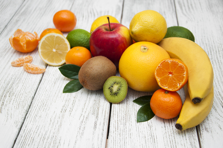 Fresh juicy citrus fruits on a white wooden backgroundの写真素材