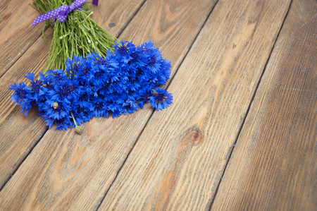 Bouquet of cornflowers on a wooden backgroundの写真素材
