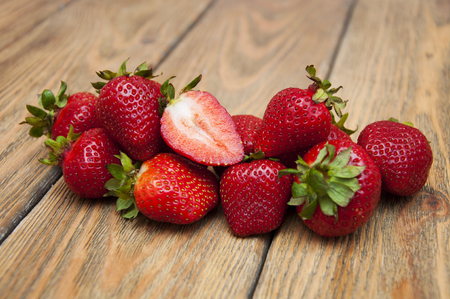Ripe red strawberries on a wooden backgroundの写真素材