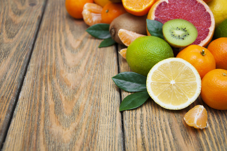Fresh juicy citrus fruits on a wooden backgroundの写真素材