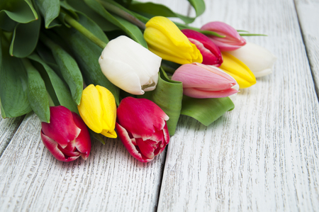 Bouquet of colorful tulips on a wooden boardの写真素材
