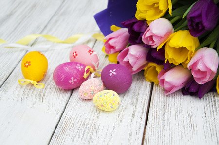 Easter eggs with tulips on wooden backgroundの写真素材