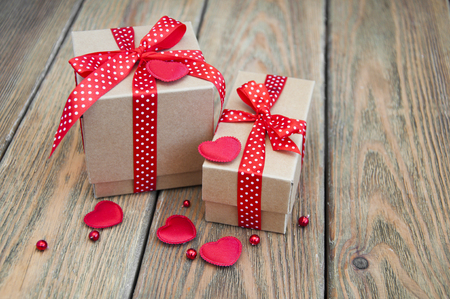 Gift boxs with red hearts on a old wooden backgroundの写真素材