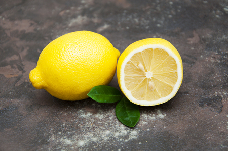 Fresh juicy lemons on stone backgroundの写真素材