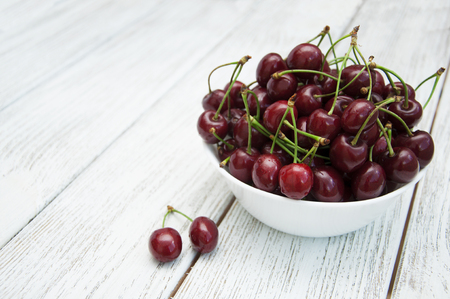Ripe juicy cherries on a wooden backgroundの写真素材
