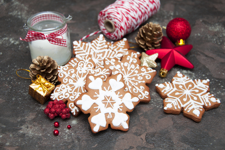 Christmas ginger cookies with christmas baubles on a stone backgroundの写真素材