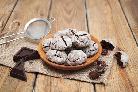 Crackled chocolade cookies on a old wooden backgroundの写真素材
