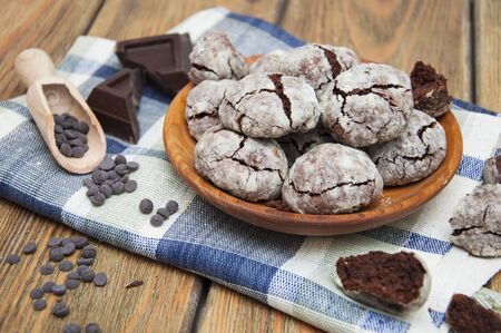 Crackled chocolade cookies on a old wooden backgroundの写真素材