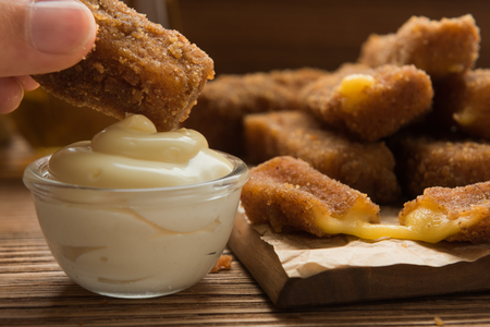 Homemade fried mozzarella sticks with white Sauceの写真素材