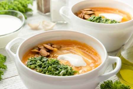 Pumpkin soup on a wooden tableの写真素材
