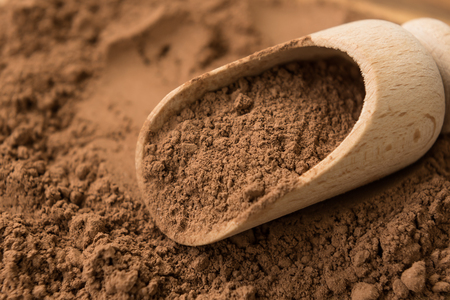 Pure cocoa powder close-up on wooden backgroundの写真素材