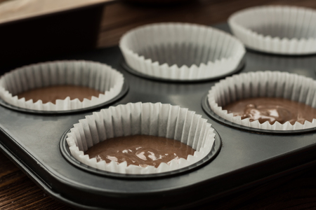 Pour dough into the mold for cupcakes or muffinsの写真素材