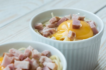 Making Italian pasta with egg and baconの写真素材