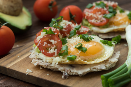 Huevos rancheros tostadas with avocado salsa with veggiesの写真素材