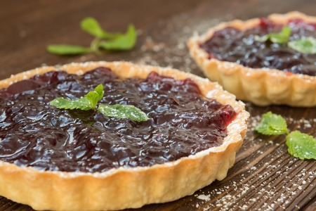 Tartlet with blackberry jam and fresh mintの写真素材