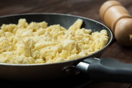 Perfect scrambled omelette with feta cheese and topped with parsleyの写真素材