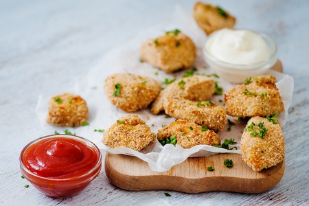 Delicious nuggets served on the board with two saucesの写真素材