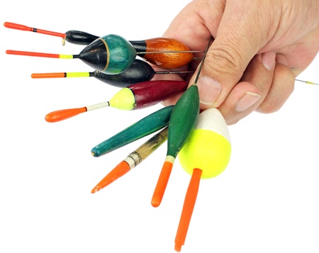 Fishing floats in hand on white background の写真素材