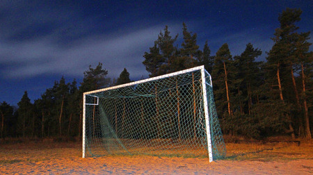 Soccer pitch under starry sky at nightの写真素材