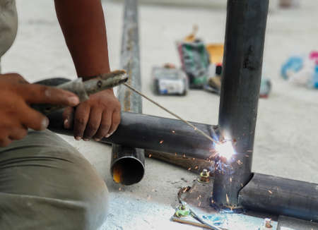 Workers welding without gloves and welding mask are not safe.の写真素材