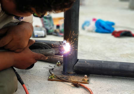 Workers do not wear personal protective equipment when welding.の写真素材